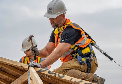 Contractor working on roof of house
