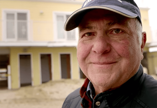portrait of man in front of home