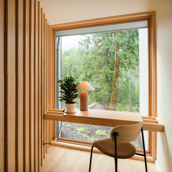 retro modern office set in front of a large picture window overlooking nature