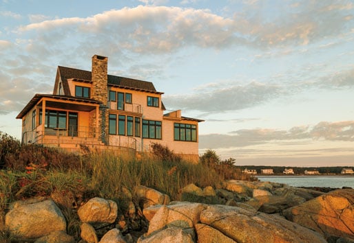 House on top of hill with water in the horizon