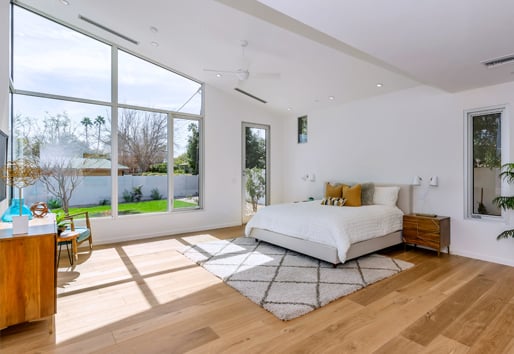 Open and airy bedroom with large windows letting in natural light